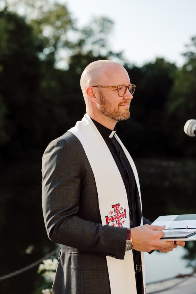 Stephen Setzer officiating outdoors in clerical collar and stole